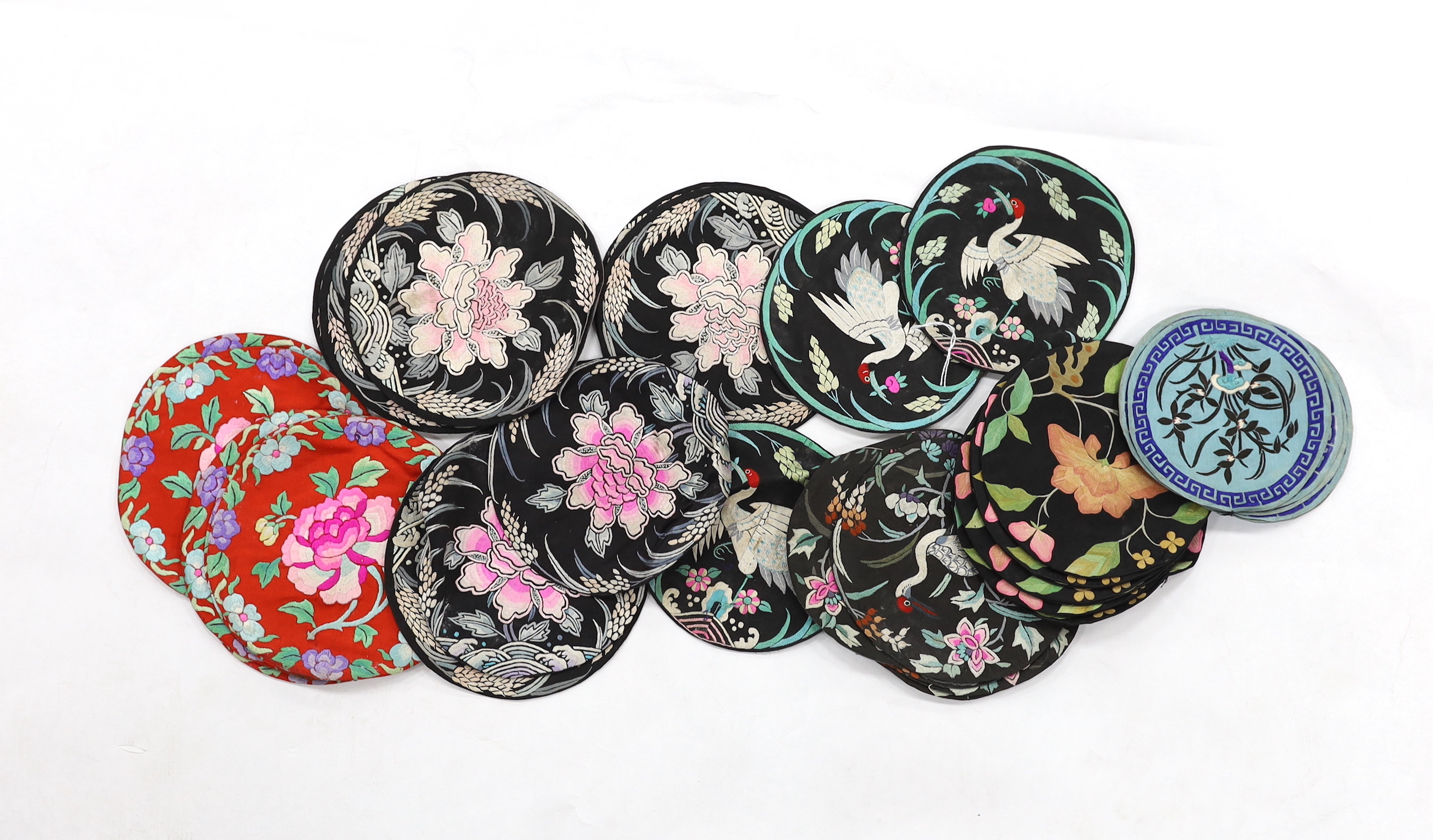 Four sets of eight circular Chinese silk embroidered mats and a set of three similar mats, all depicting birds and stylistic flowers